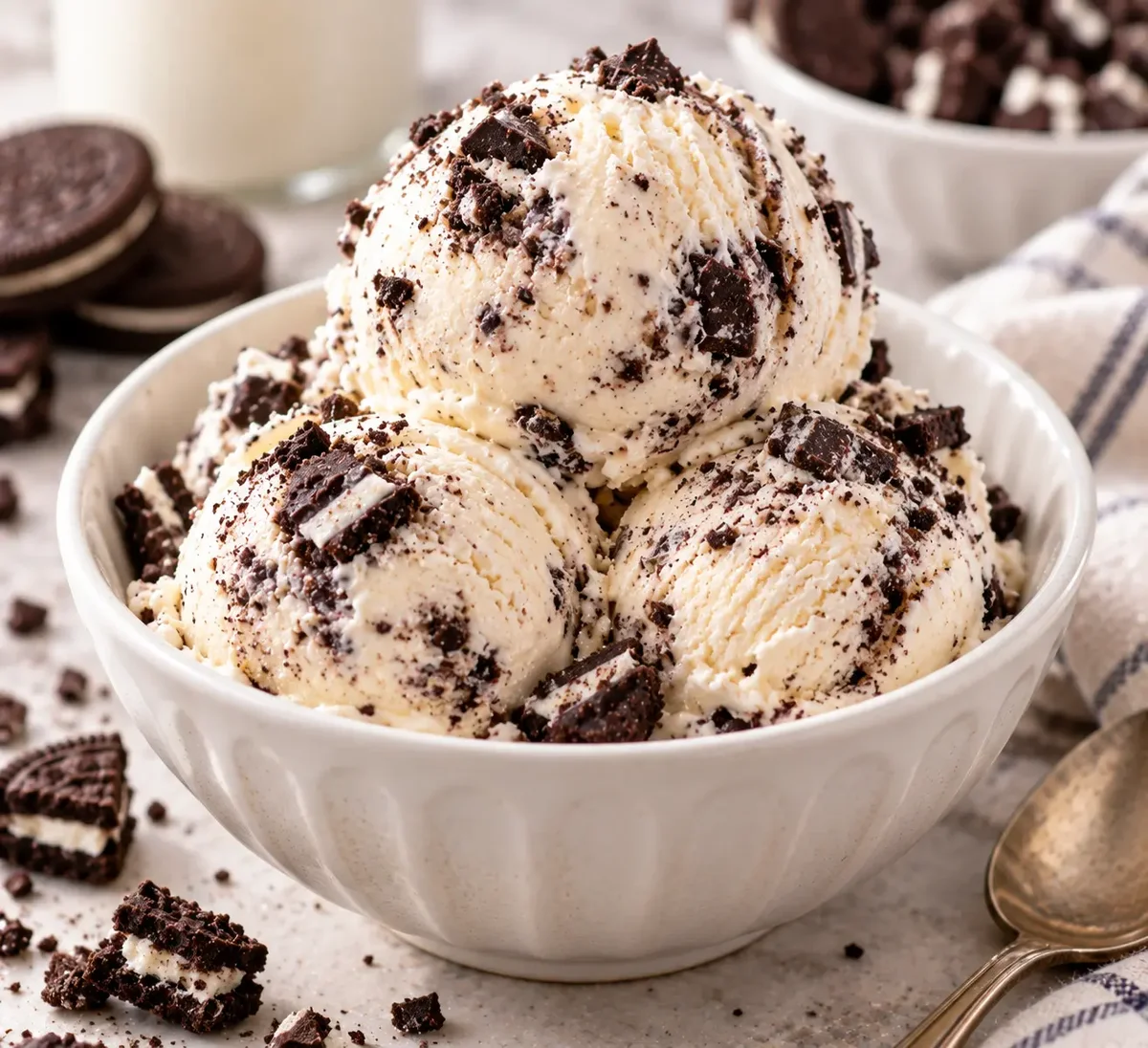 Scoops of cookies and cream ice cream with crushed cookie pieces